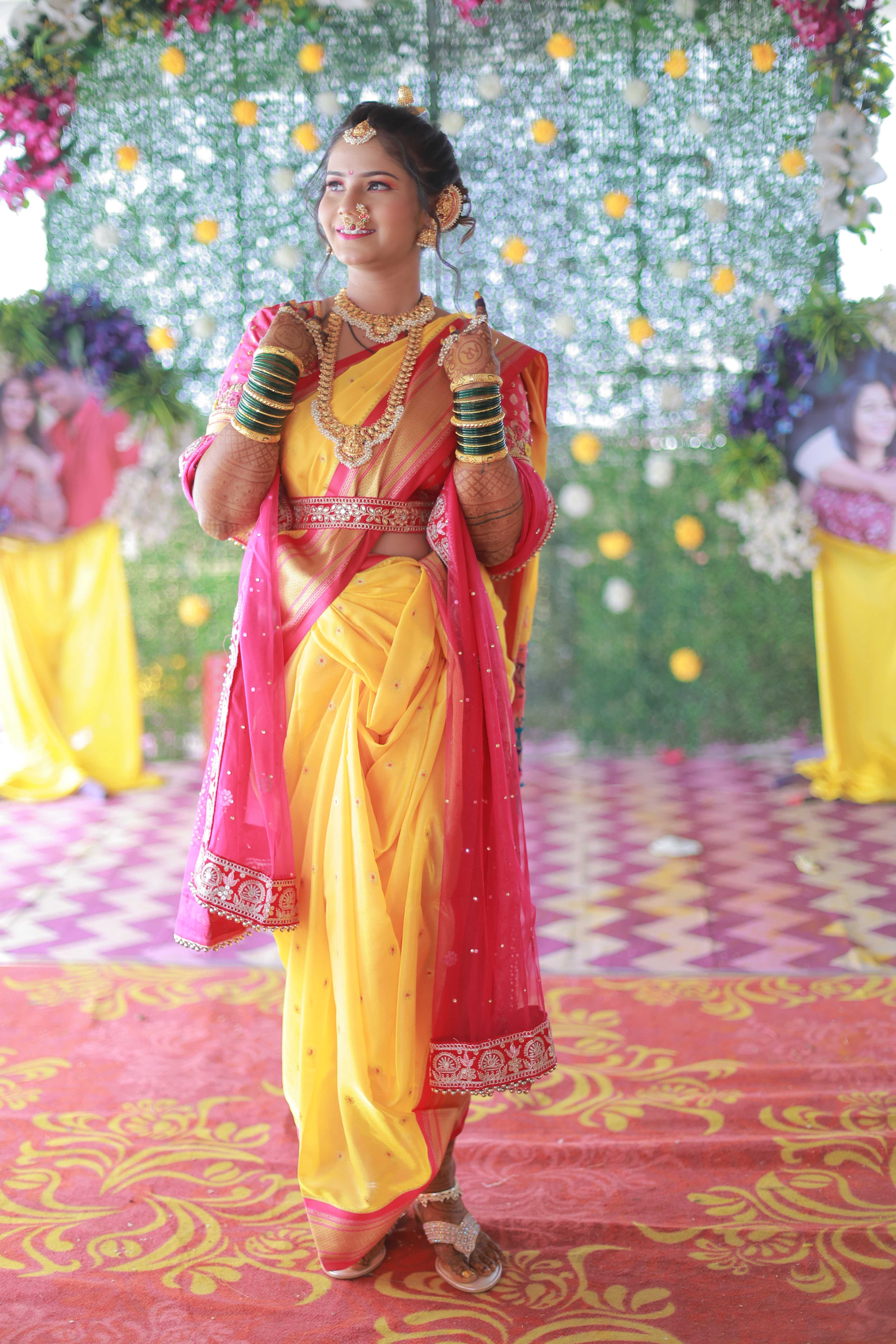 Candid full-length traditional bride in yellow saree with jewelry