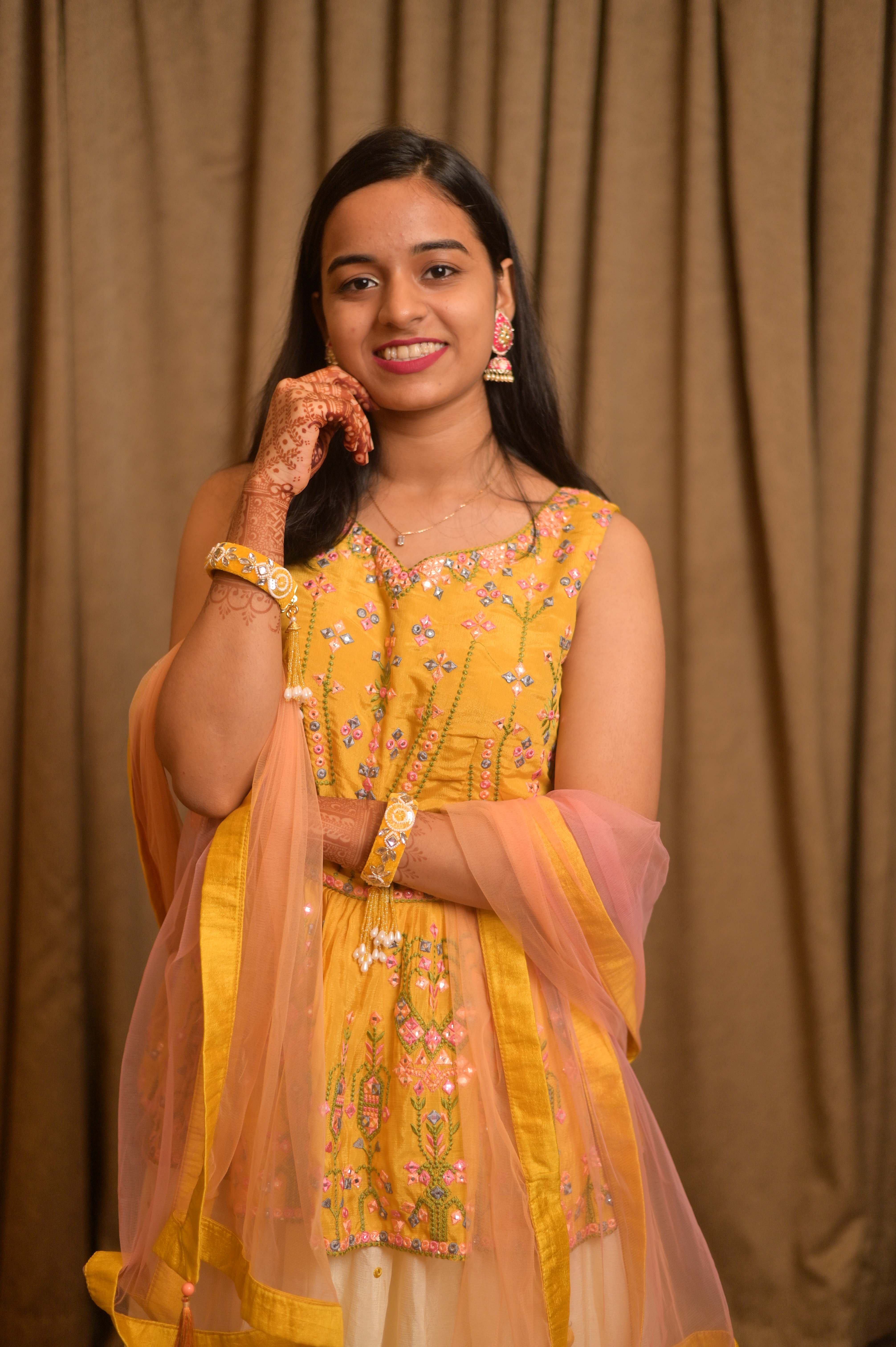Candid bride in yellow anarkali suit with soft pink dupatta